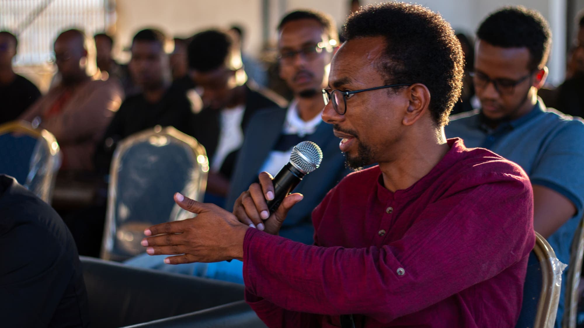 An audience member asks a question with a microphone